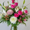 A pink, red, and white Valentine's Day floral arrangement typically features a