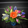 This beautiful blue textured vase is filled with springtime blooms! Fragrant hyacinth