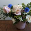An organic, flowy arrangement with pops of blue corn flower that reminds
