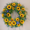 The wreath measures 21 inches in diameter. The flowers on the wreath