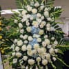 A standing spray with all whites with blue Hydrangea accents. Option to