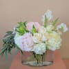 A compact and simple arrangement that features beautiful Peonies. 