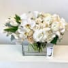 A mostly neutral and white blooms arranged in a compact style in