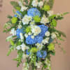 A standing spray with hydrangeas, roses, spray roses, spider mums, snap dragons