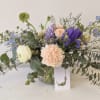 A small arrangement in a hobnail glass jar with pastel tones. 