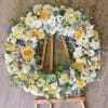 A standing 24 inch diameter Wreath on a wooden easel (included) that