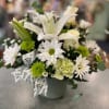 A tranquil design of Green and White flowers such as lilies, roses