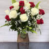 This elegant arrangement features rich red and creamy white roses beautifully balanced