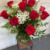 A classic arrangement of vibrant red roses accented with delicate baby&rsquo;s breath