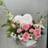 Pink and White flowers in a heart-shaped ceramic container for your loved