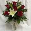 A simply elegant arrangement with 6 red roses and a pink or
