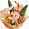A tropical statement bouquet in rich shades of peach, blush, orange, and
