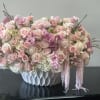 Soft tender pinks blended with delicate peach blooms and a curated assortment