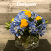 Glass cube vase with blue hydrangea and yellow roses.  Due to