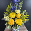 Like a sunny day, this beautiful blue, yellow and white bouquet is