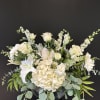 A delicate and peaceful all white arrangement. Full of lilies, gerbs, hydrangeas