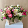 Spring is around the corner in this wooden box filled with Tulips