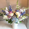 This asymmetric arrangement exudes timeless elegance with a refined palette of blue