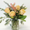 Beautiful peach roses, hypericum berries and waxflower.