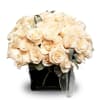 A modern arrangement of four dozen White roses filled in a classy