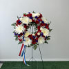White, blue and red wreath 
Flowers and color substitution might apply