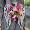 Metal wings designed with artificial floral and designer ribbon,  custom made
