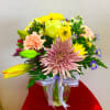 A spring bouquet containing carnations, lilies, spider mums, etc..