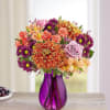 All-around arrangement with lavender roses, purple daisy poms and waxflower, mini orange