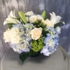 A simple classic arrangement of blue and whites, hydrangeas, roses, spray roses