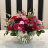 This arrangement has an assortment of beautiful pink, red, and white flowers.