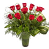 Classic one dozen of red roses designed tall in a glass vase.
