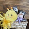 Fun gift basket filled with a beautiful candle, hand lotion, Warmie, care