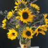 Gorgeous Sunflowers in tall cylinder vase, accented with purple statice and lavender