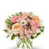 This beautiful flower arrangement features a soothing blend of peach roses, pink
