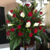 Bold red roses and sculptural white calla lilies come together in this