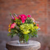 Bold and bright flowers arranged in an all around fashion in a