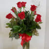 A dozen roses in a glass vase