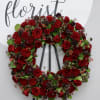 This wreath includes premium Ecuadorian red roses mixed with seasonal greenery. 

We