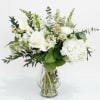 This all-white arrangement contains hydrangea, callas, stock, snap &amp; more.