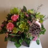 Lush green flowers, succulents, with pinches of pink, lotus pods and orchids