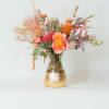 A stunning celebration of warm hues and natural textures, this arrangement features