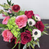 An elevated blend of deep red roses, ruffled blush garden roses, and
