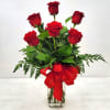 Half a dozen premium red roses, elegantly arranged with fresh greenery. A