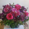 Arranged with rich jewel tones. Purple, plum and hot pink flowers, such