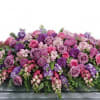 Like a heartfelt embrace, this beautiful casket spray delivers comfort and love