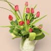 Brighten any space with our fresh tulips arranged in a stylish ceramic