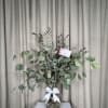A sophisticated and fresh arrangement where eucalyptus takes center stage. Its aromatic