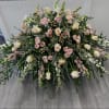 Console and comfort with this luxurious casket spray of pale pink, peach