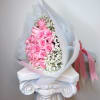 A bouquet of pink roses paired with gypsophila, wrapped in white paper.