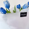 A bouquet of 10 tulips in deep, marbled shades of blue wrapped